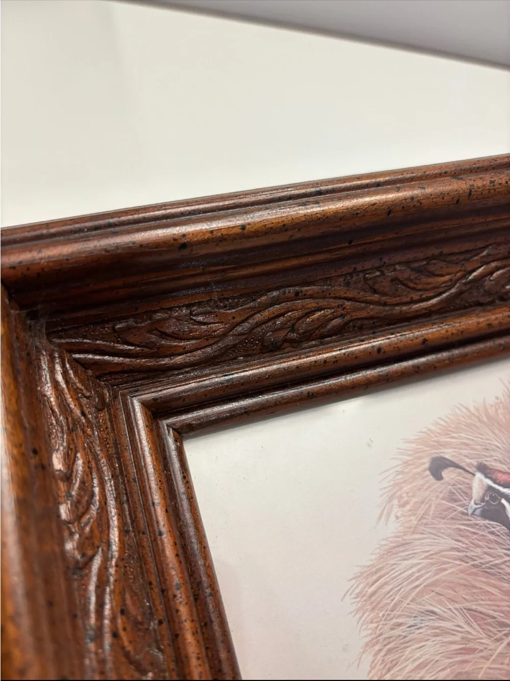 Vintage quail wall art with a rustic, carved wood frame
